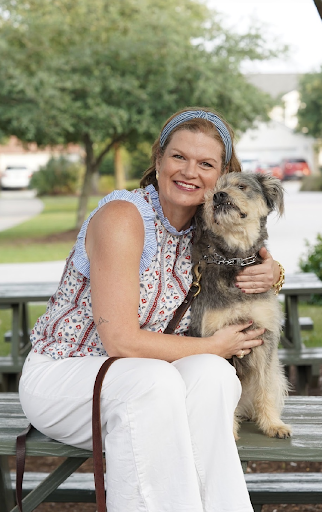 Jaclyn Michelle Smith hugging her shaggy dog outdoors
