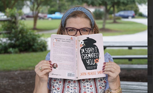 Jaclyn Michelle Smith holding her book, 'I'm Sorry I Cremated You'